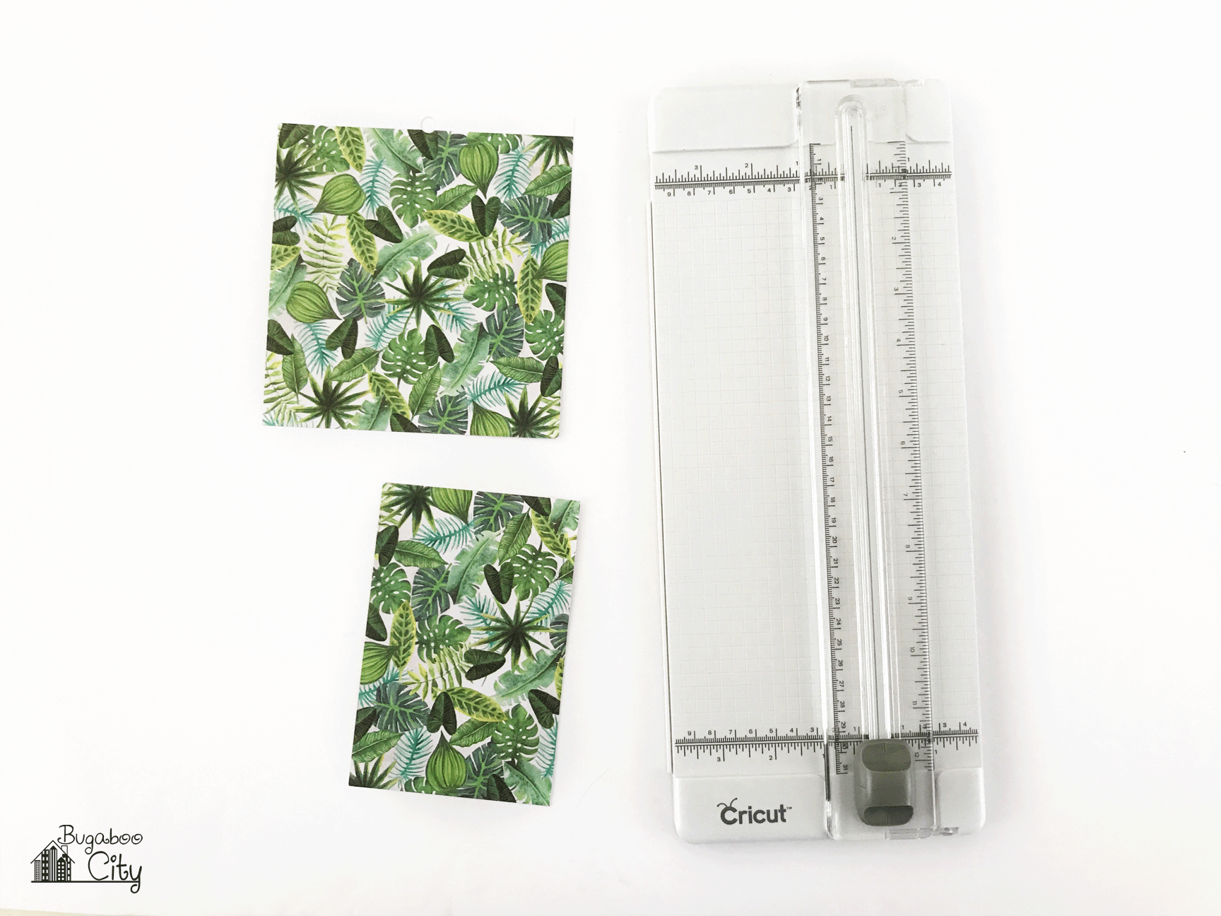 Leaf-print paper lays next to a paper trimmer.