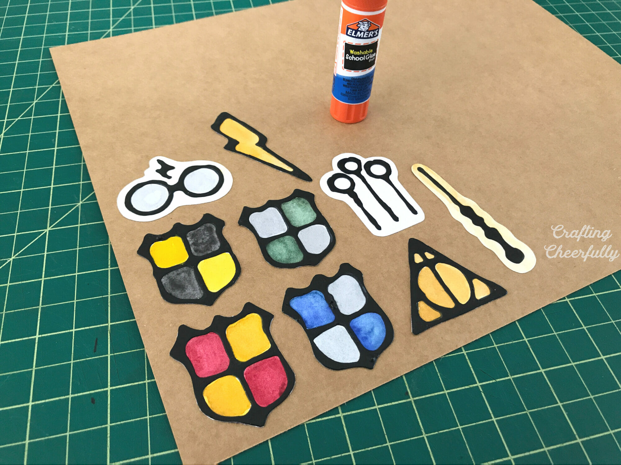 Harry Potter magnets are glued to chipboard using a gluestick.