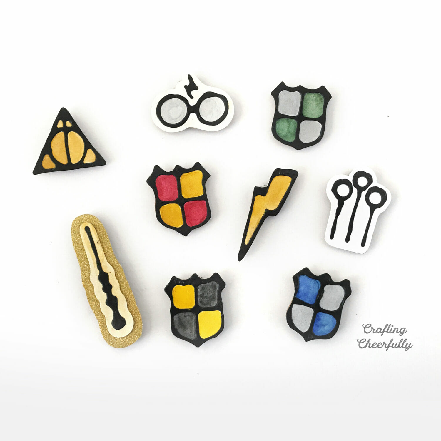 Harry potter magnets made with black glue lay on a white table.