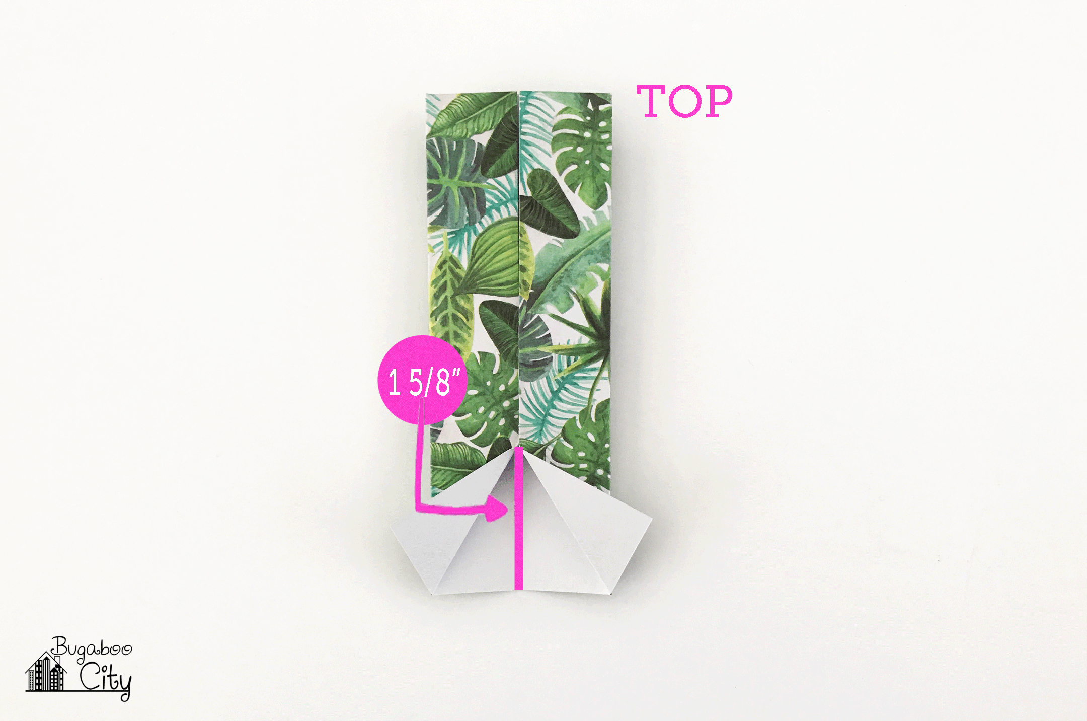 Bottom of the rectangle is folded outward creating the sleeves of the shirt.