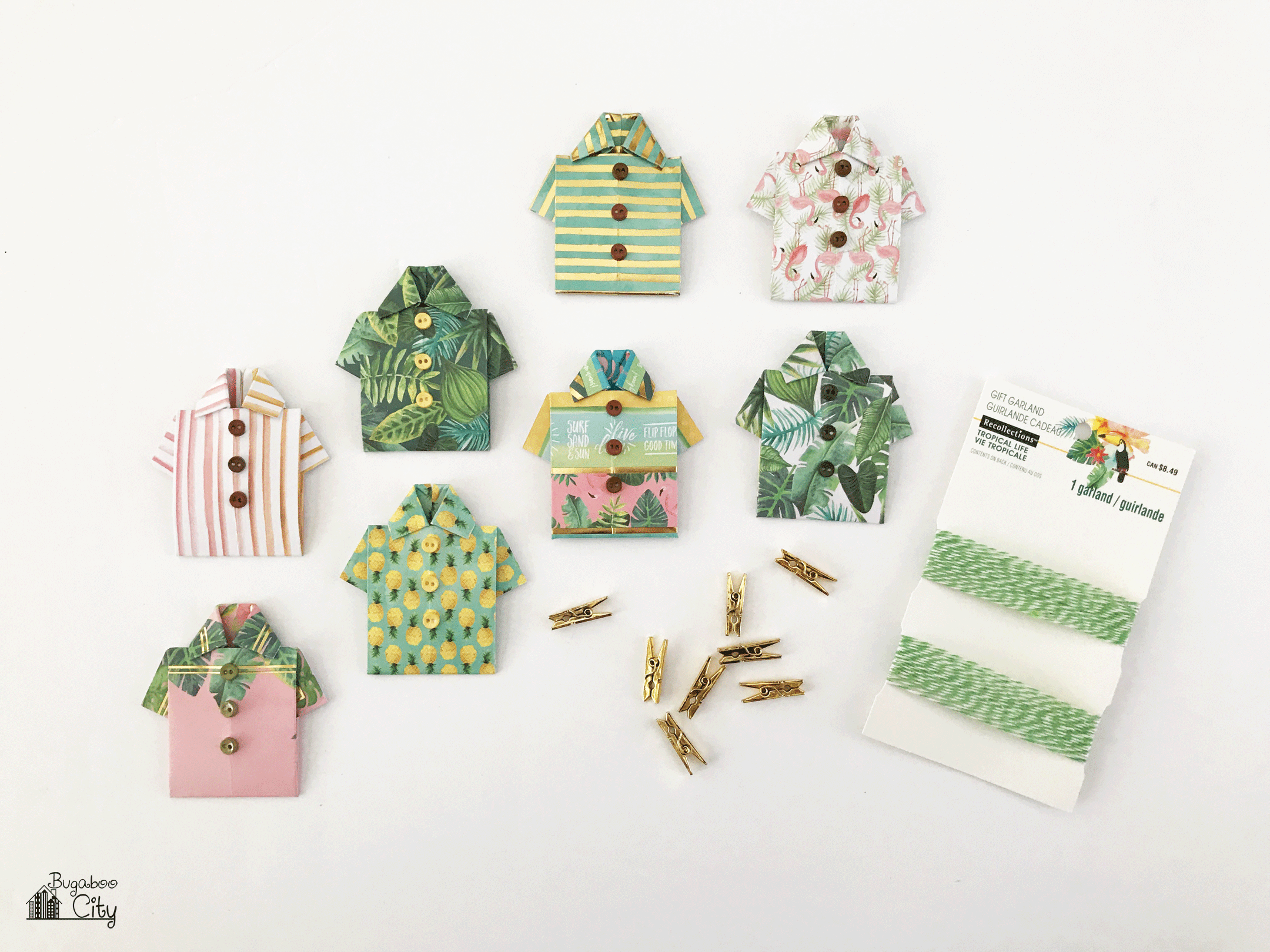 Tiny paper shirts are hung on twine with mini gold clothespins.
