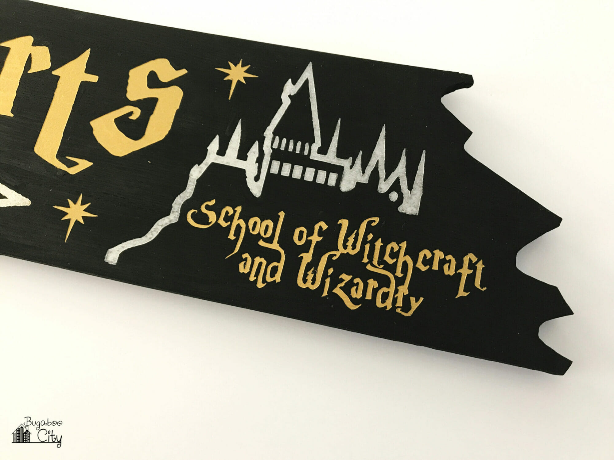 An outline of Hogwarts is painted on one end of the sign; underneath reads School of Witchcraft and Wizardry.