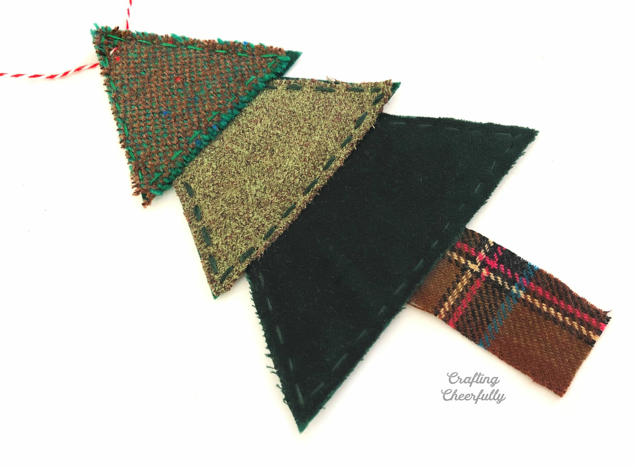 Christmas tree banner pennant made from scraps of green wood and brown wool for the trunk.