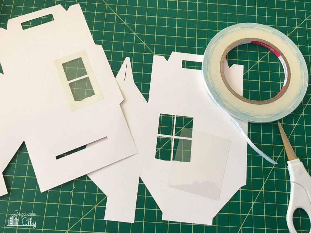 Craft plastic is attached to the back of the window using double-sided tape.