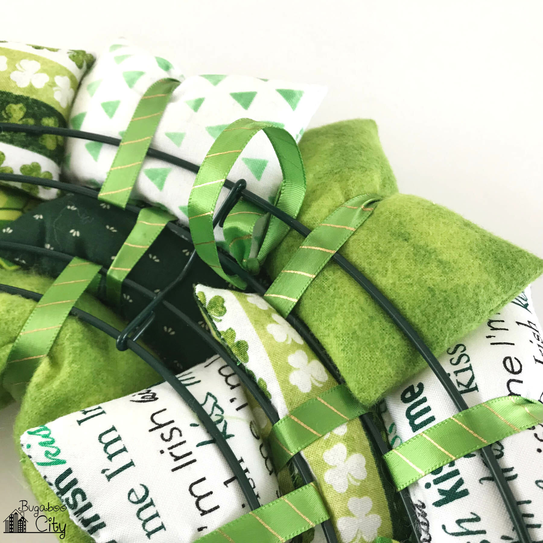 A green ribbon hanging loop is attached to the back of the wire wreath.