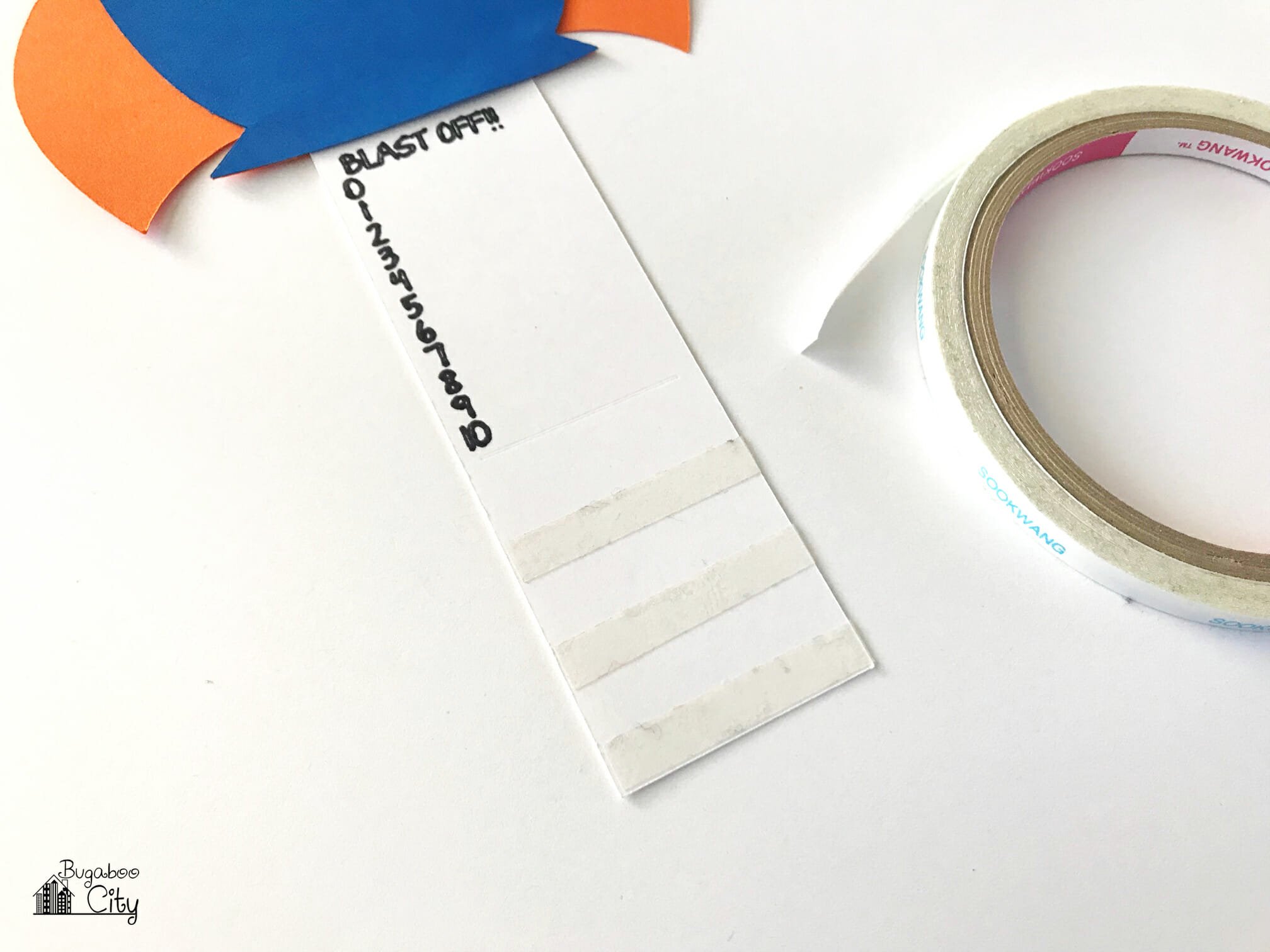 Strips of double-sided tape are applied to the bottom of the slider card.