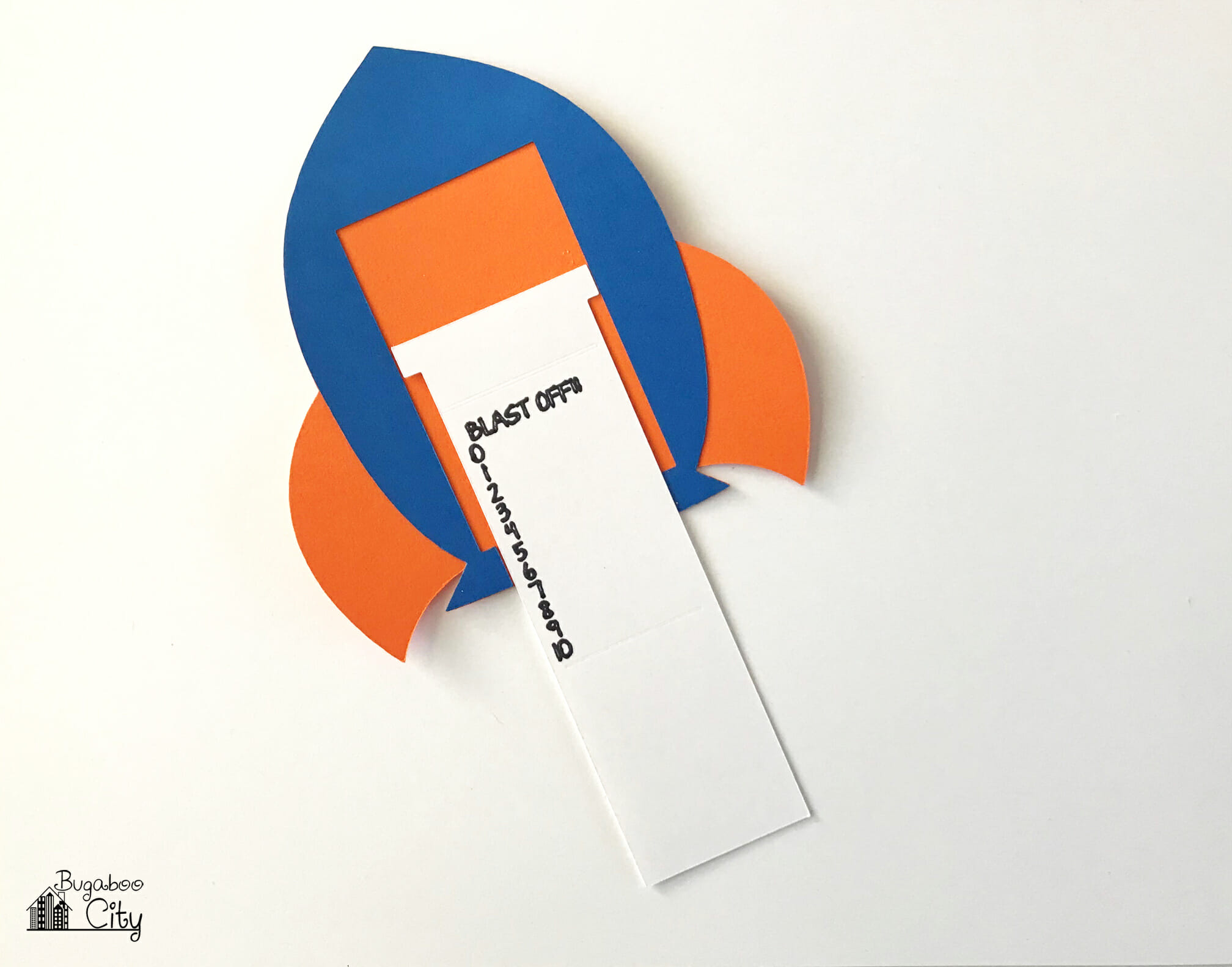 The insert is laid in the cut out area of the rocket ship card.