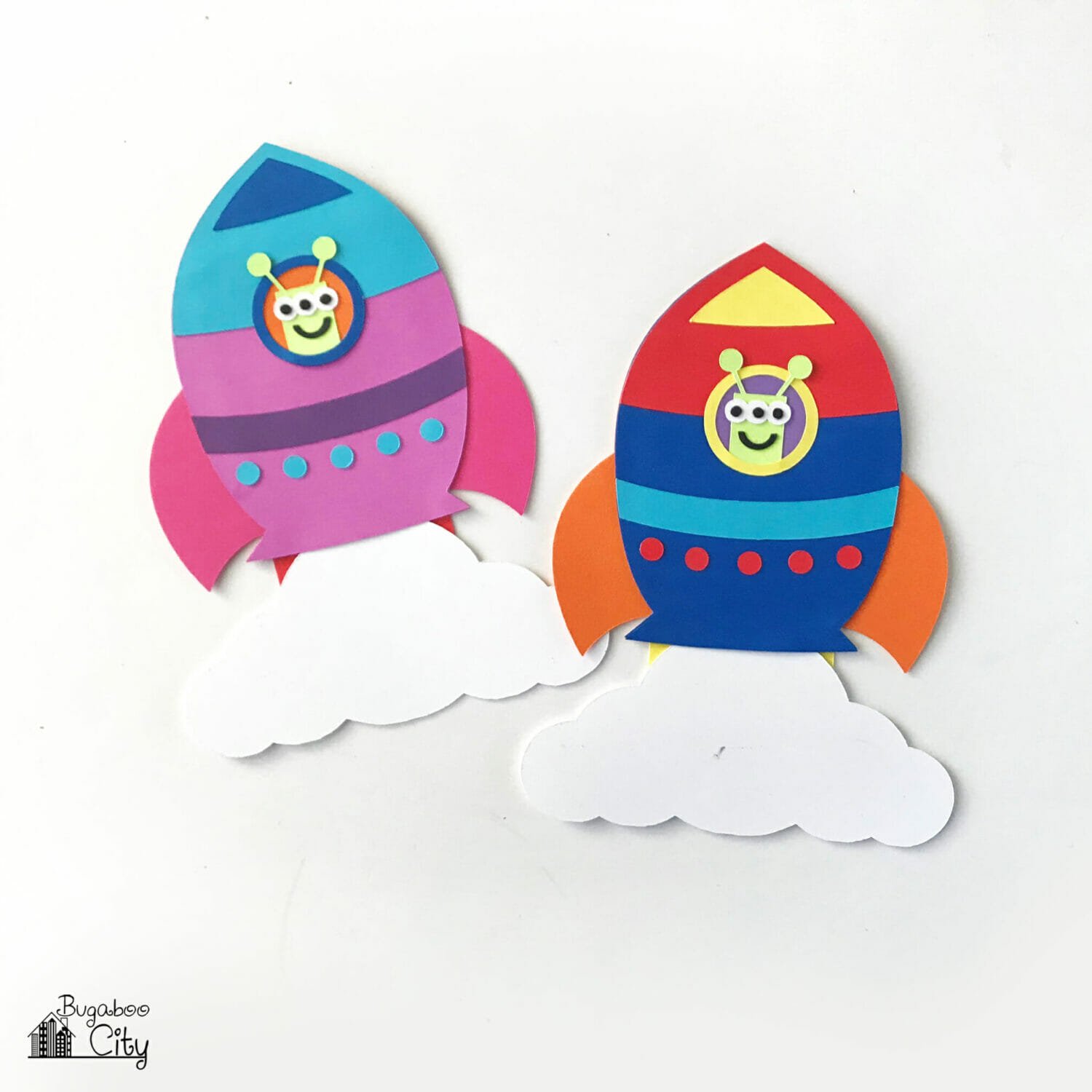 Two colorful rocket ship paper cards.