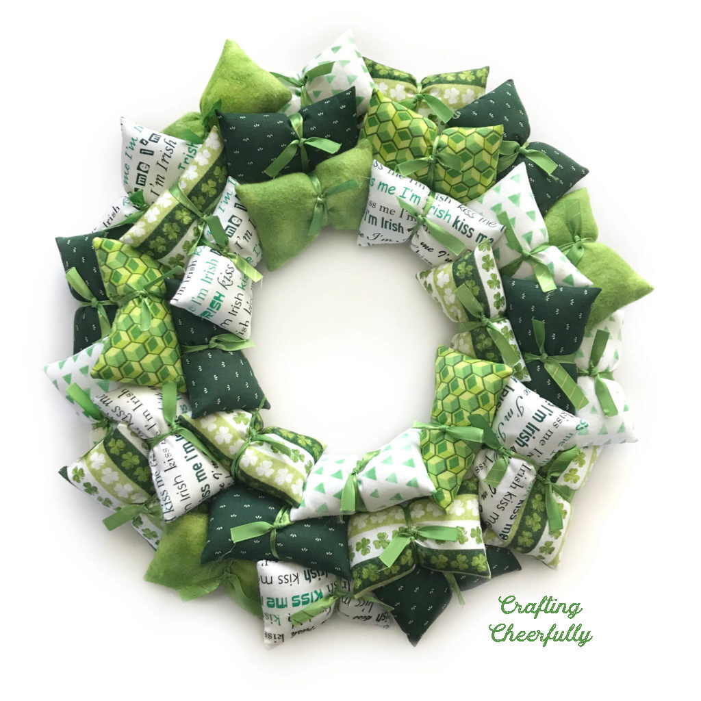 Pillow wreath made with green and white fabrics.