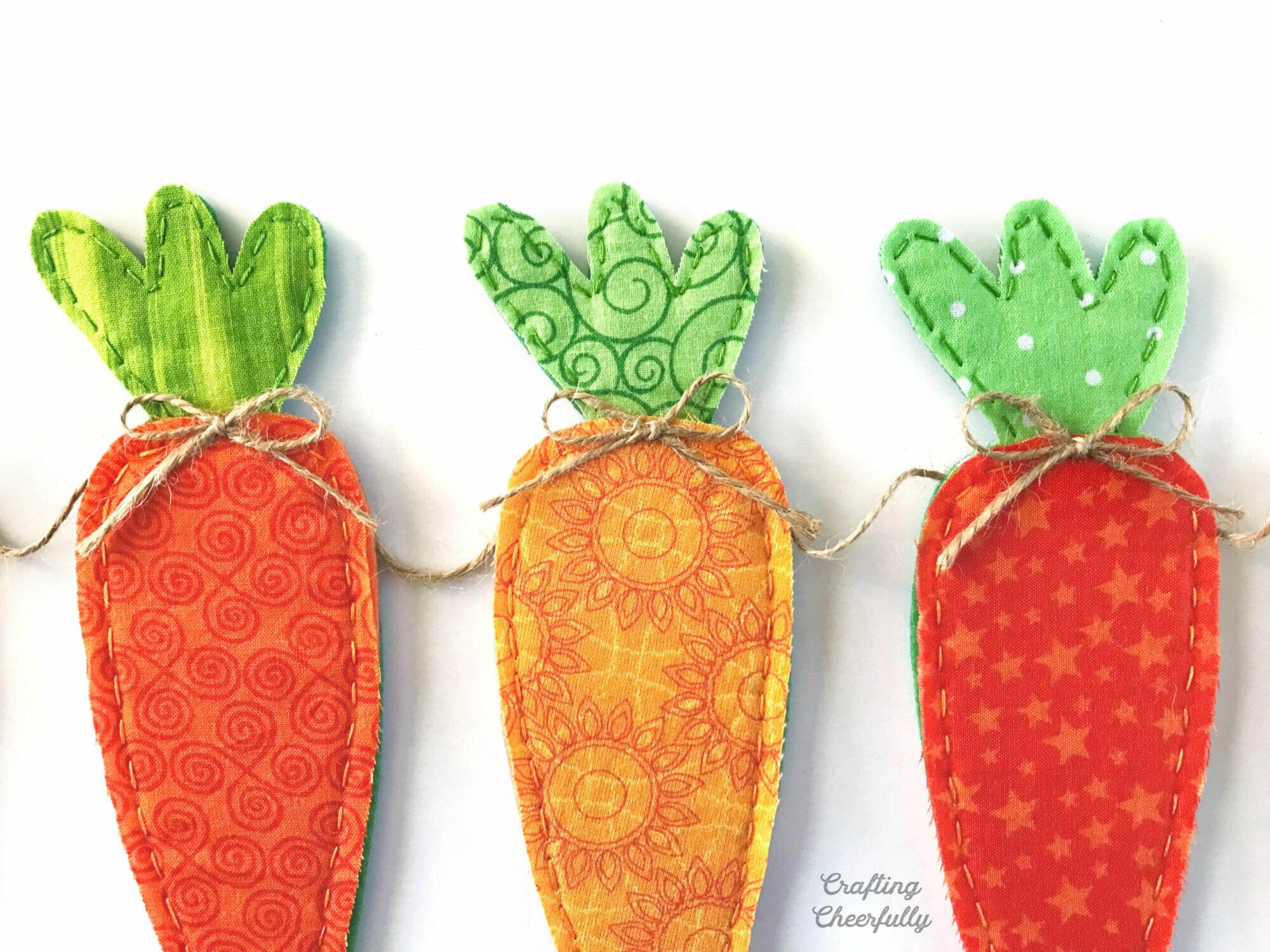 Orange fabric carrots strung into a banner along twine.
