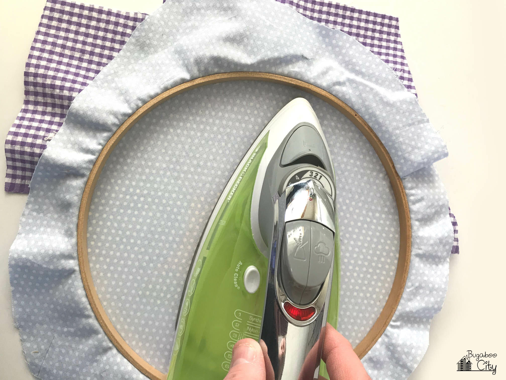 Appliqué design is ironed from the back of the hoop.