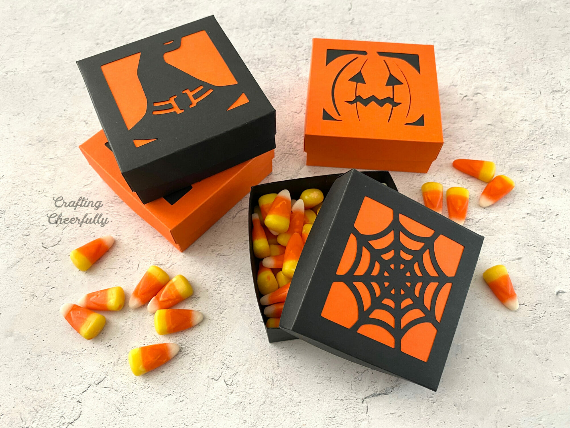 Halloween-themed treat boxes filled with candy corn.