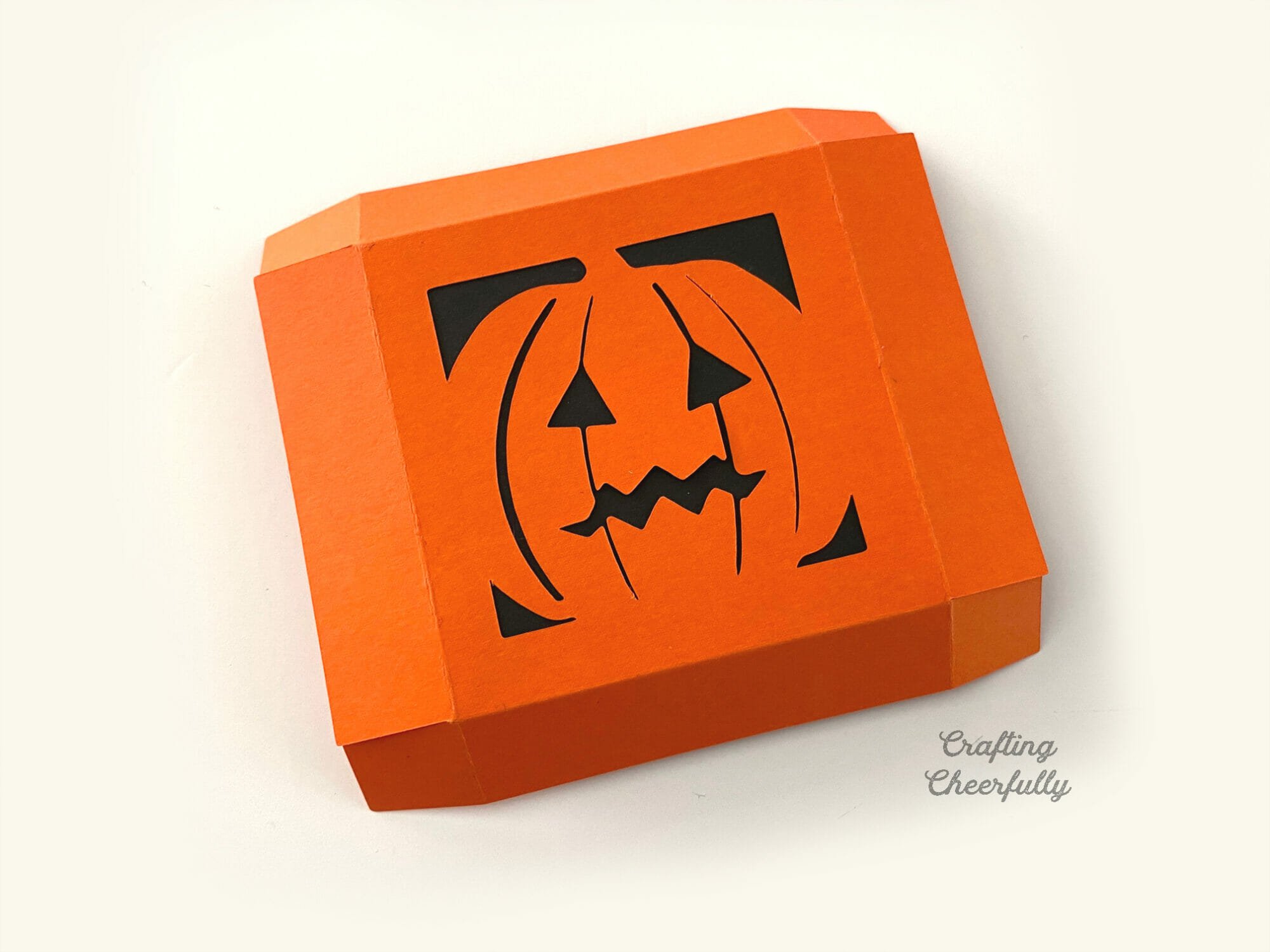 DIY Pumpkin treat box made from orange and black construction paper.