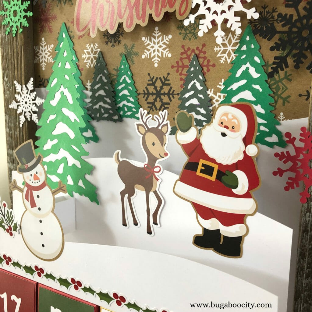 The top of the Advent Calendar featuring a winter wonderland scene created with paper.