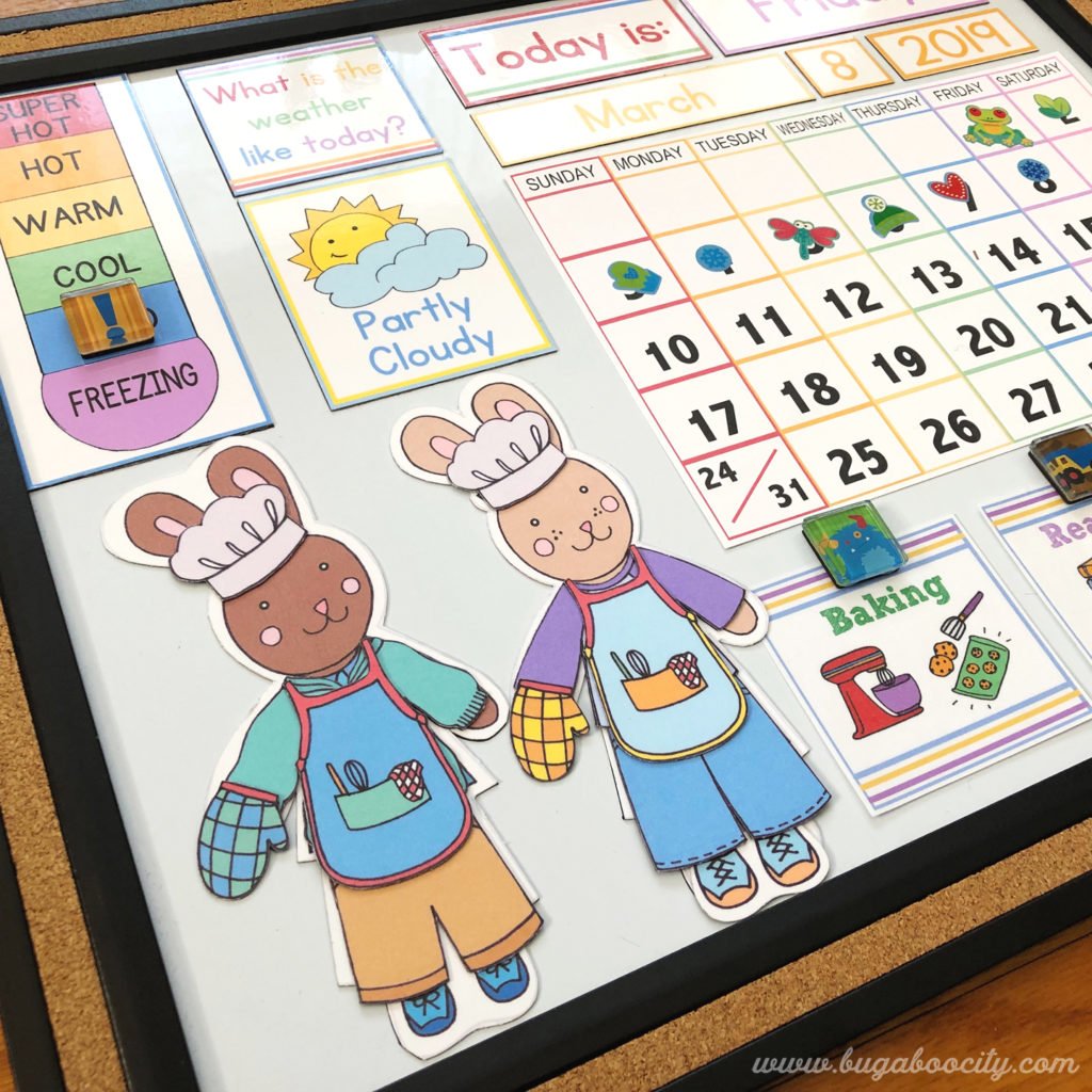 Two bunny paper dolls dressed for baking in aprons, chef hats and they have oven mitts on.