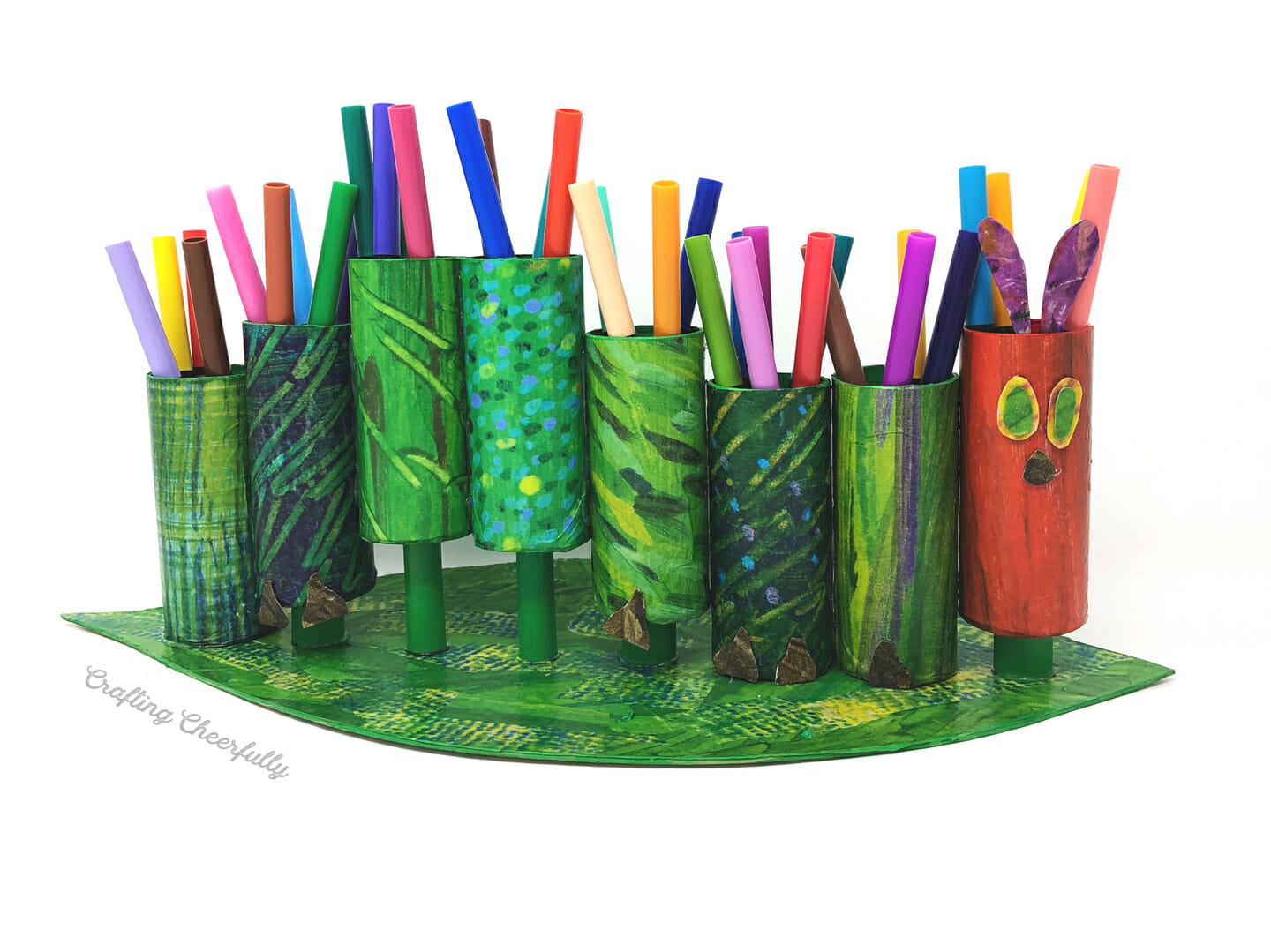Hungry Caterpillar marker holder made from cardboard tubes and patterned tissue paper.