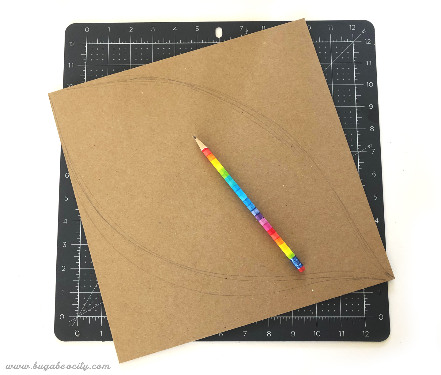 Leaf drawn with pencil on a piece of chip board.