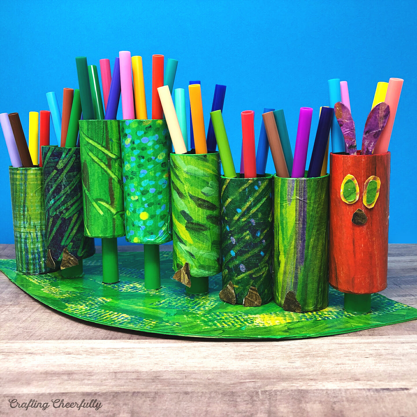 Hungry Caterpillar marker holder made from cardboard tubes and patterned tissue paper.