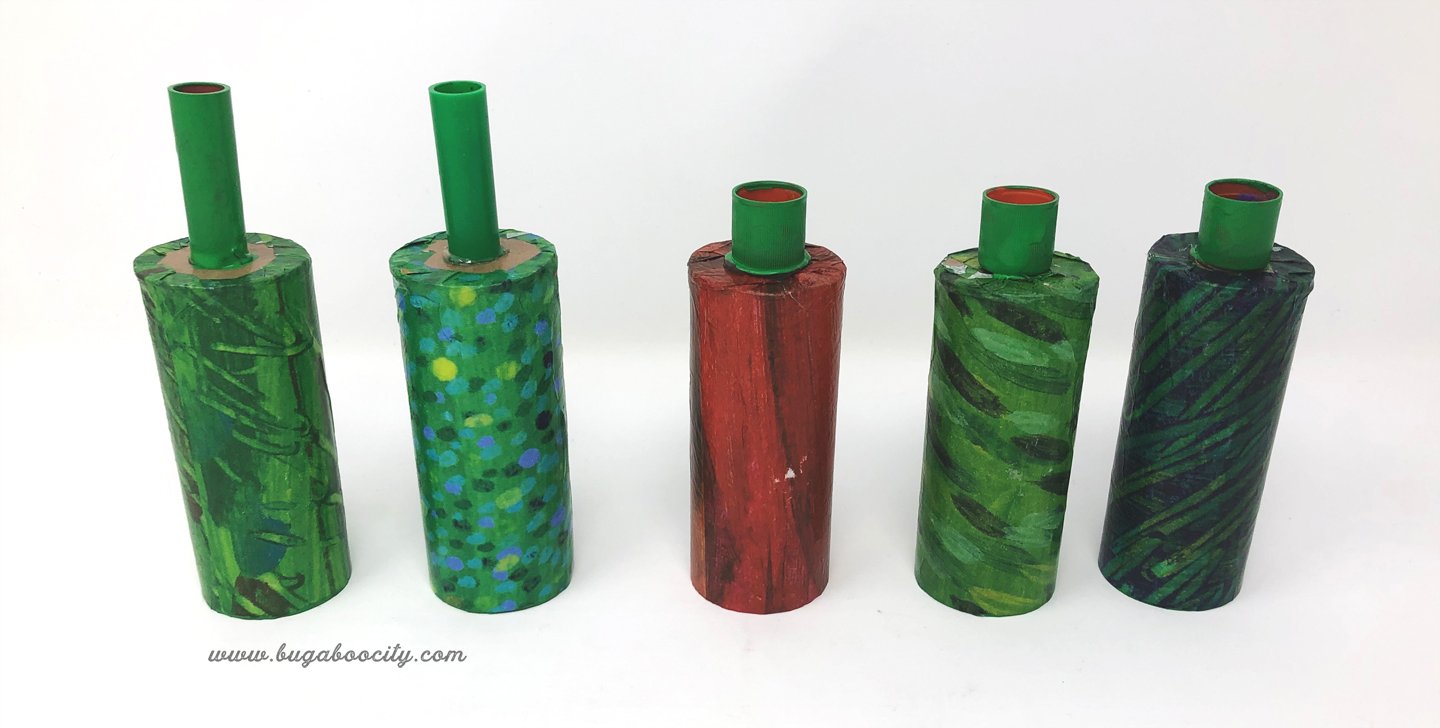 Marker and glue caps are attached to the bottom of the cardboard tubes.