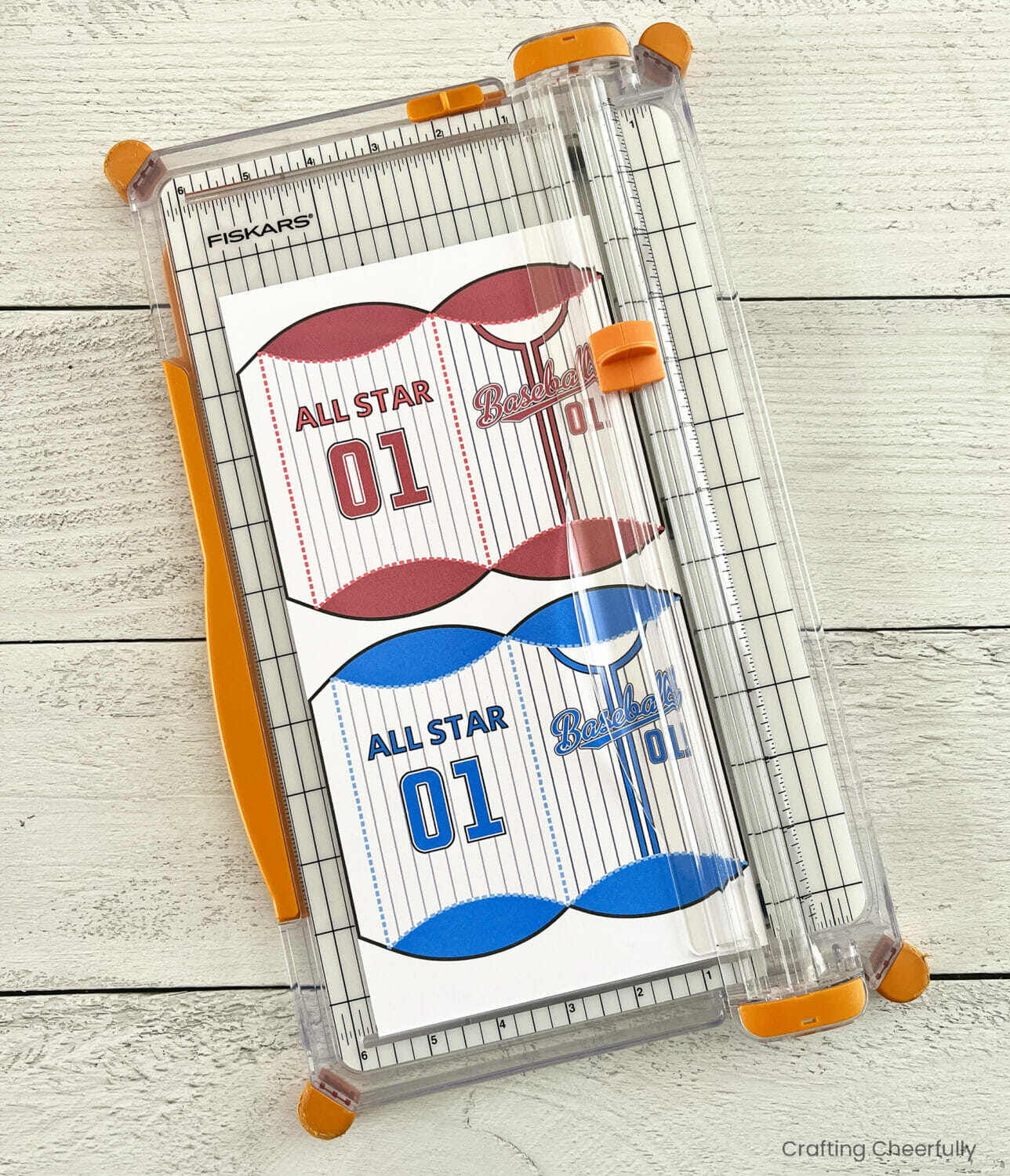 Baseball treat boxes are cut with a paper trimmer.