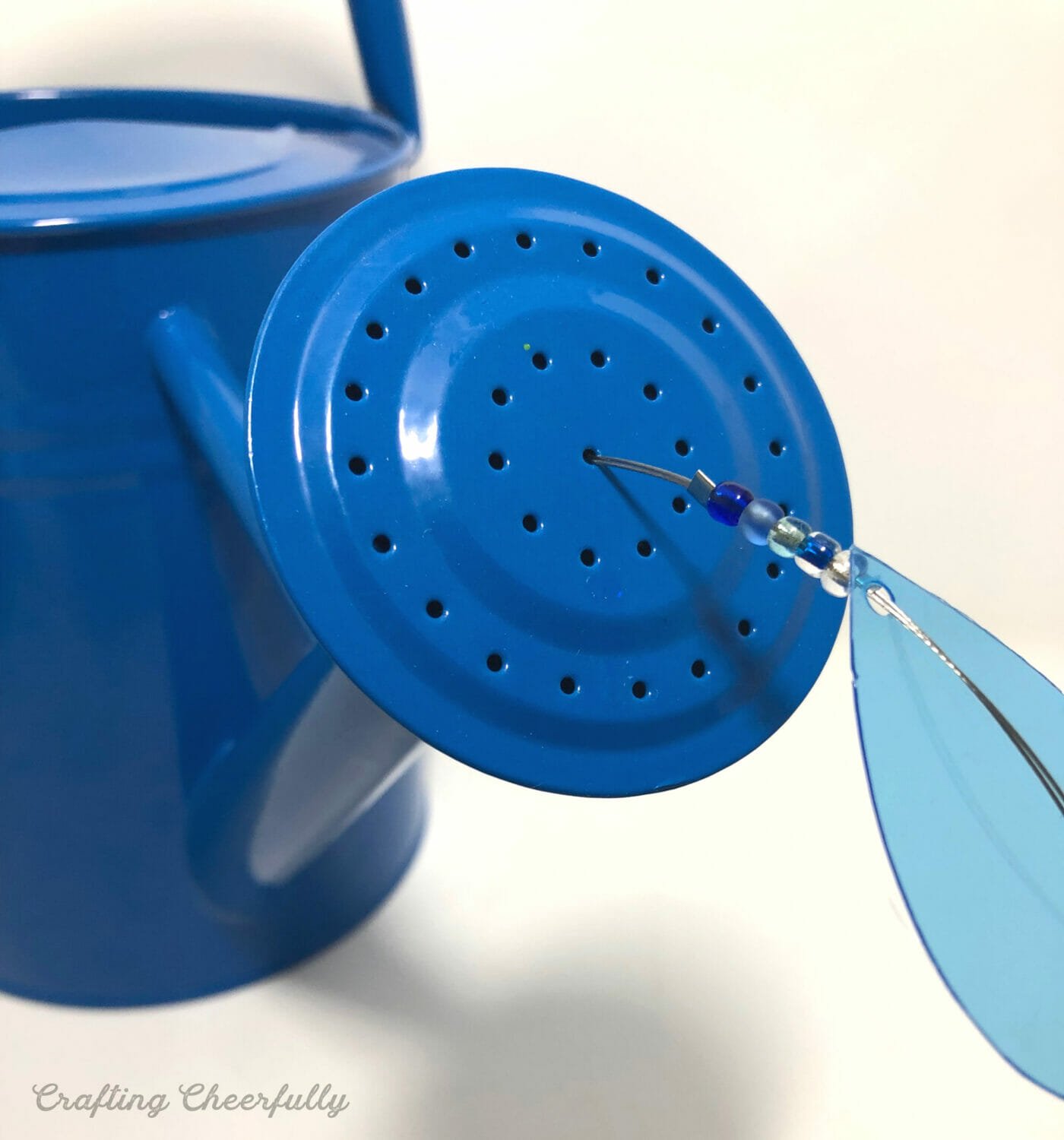 One water bead strand is sticking out of a hole in the water sprout.