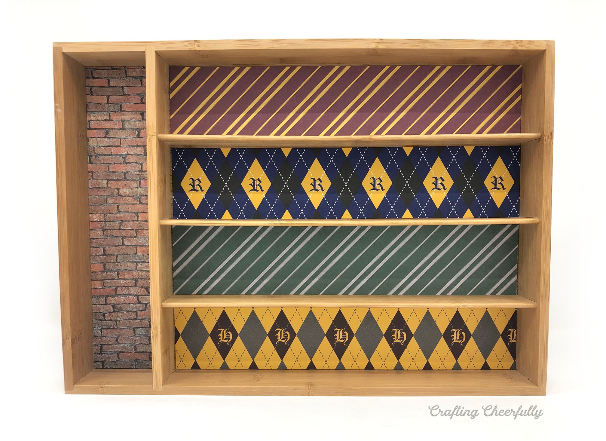 Bamboo drawer organizer lined with Harry Potter scrapbook paper.
