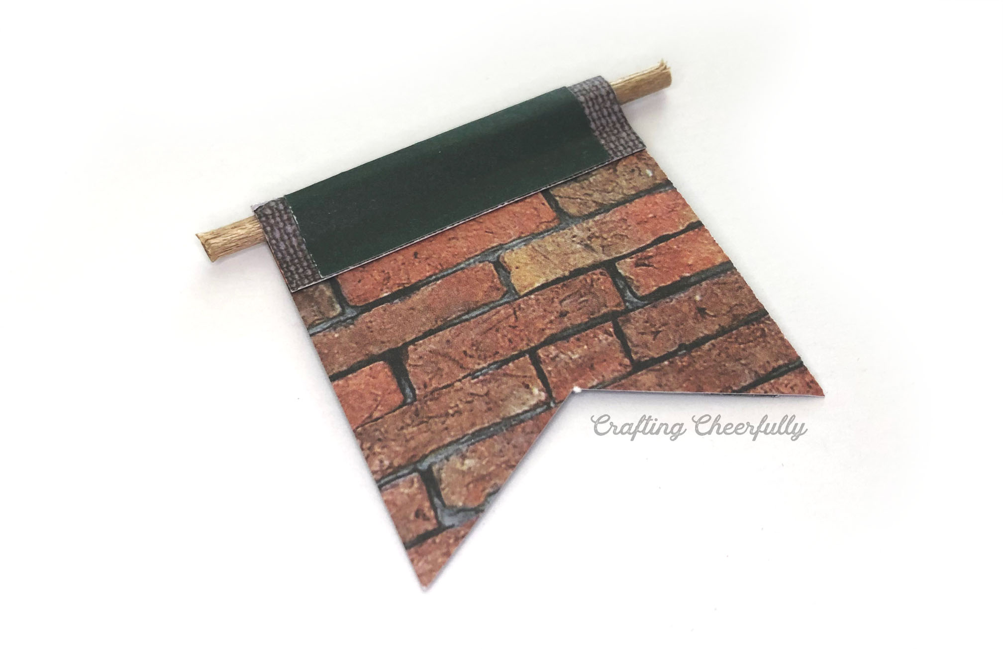 The banner is wrapped around a small wooden dowel.