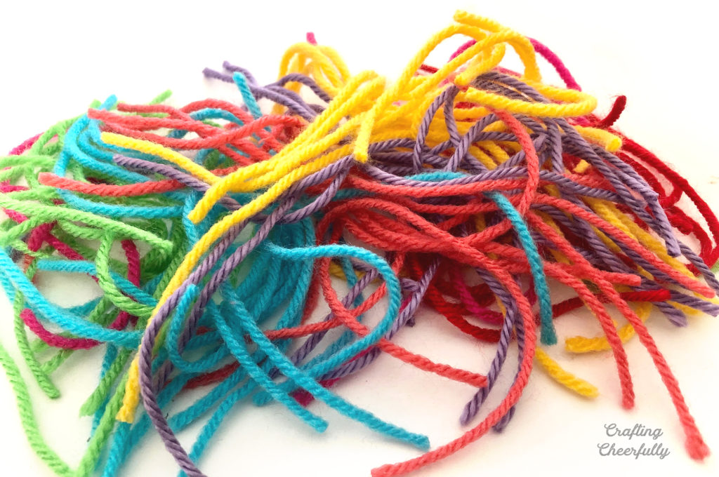 Colorful pieces of yarn lay in a group.