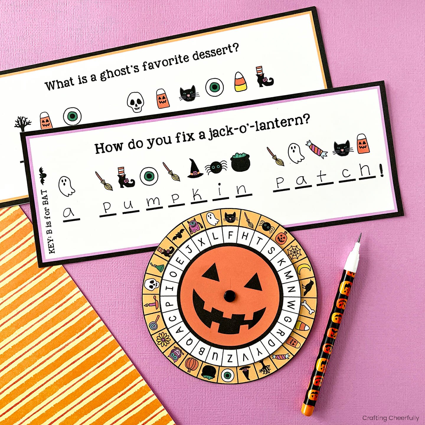 Halloween cipher wheel lays next to two secret messages.