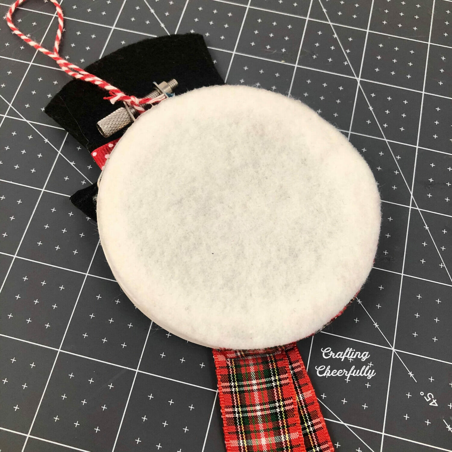 The back of the embroidery hoop covered in white felt.