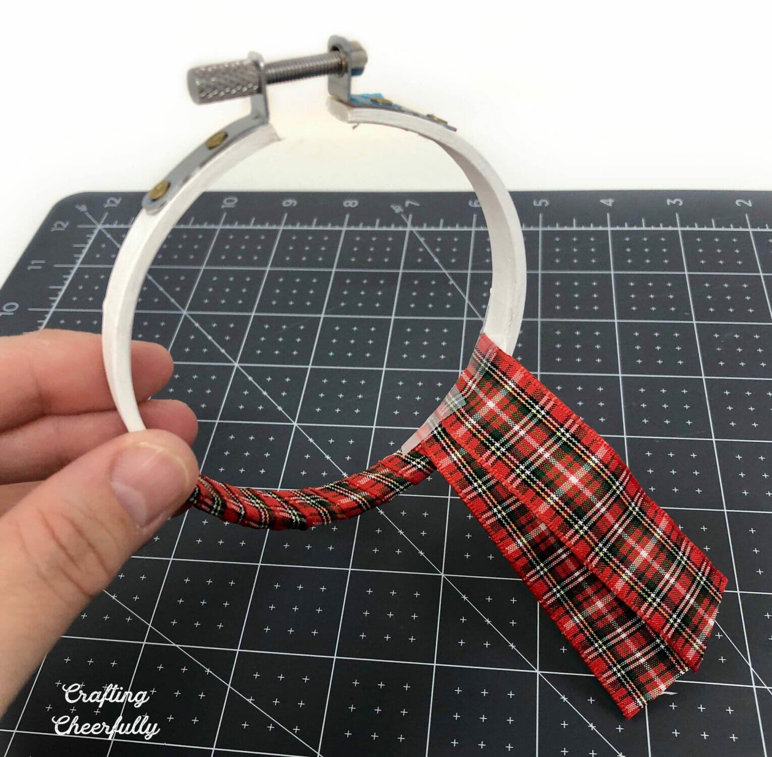 Ribbon is wrapped around the bottom of the hoop to create a scarf.