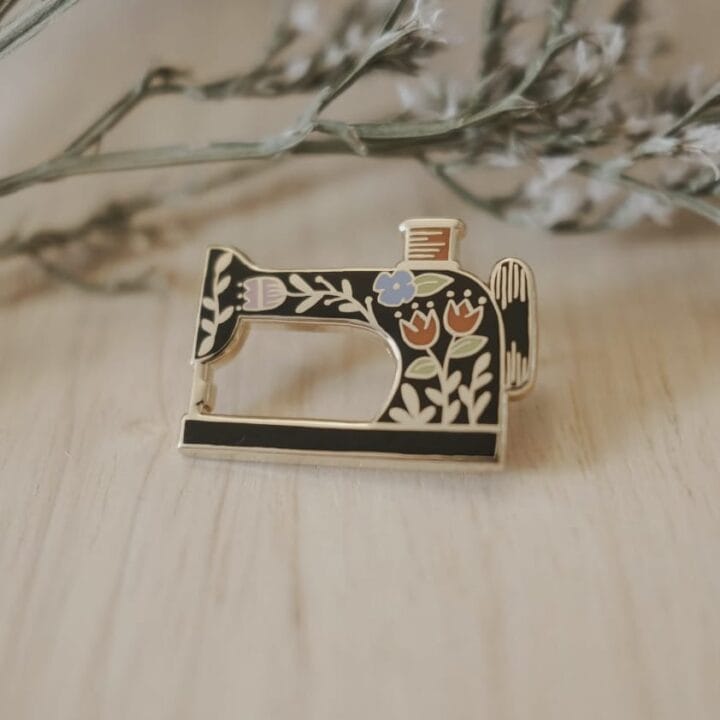 Vintage sewing machine enamel pin by Justine Gilbuena.