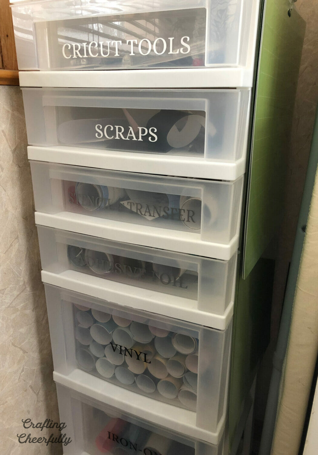 Storage tower with drawers labeled for different Cricut supplies.