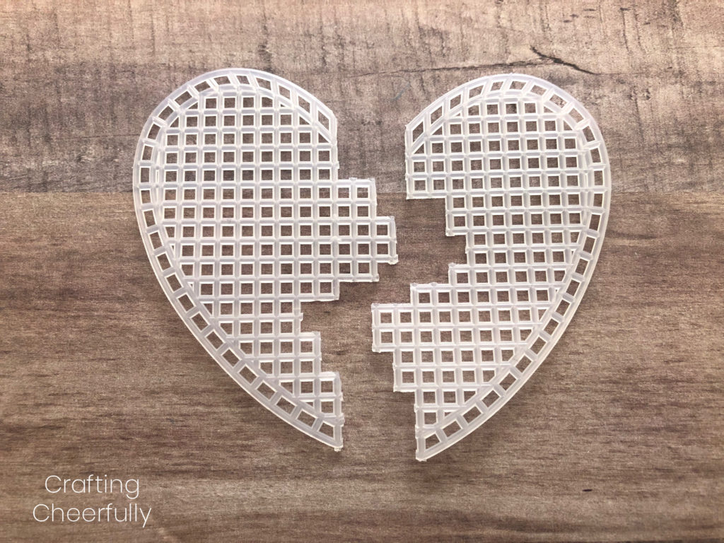 Two pieces of heart-shaped canvas both cut jaggedly in half, they fit together perfectly like a puzzle pieces.