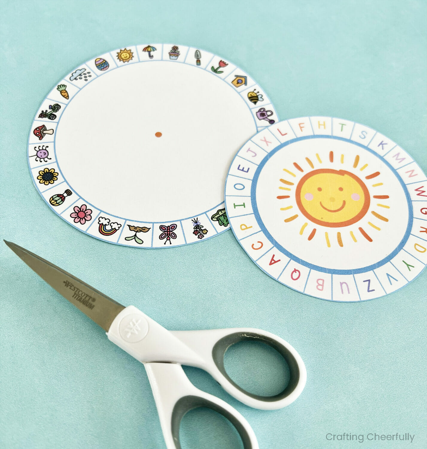 Two wheels are cut out and lay next to a scissors.