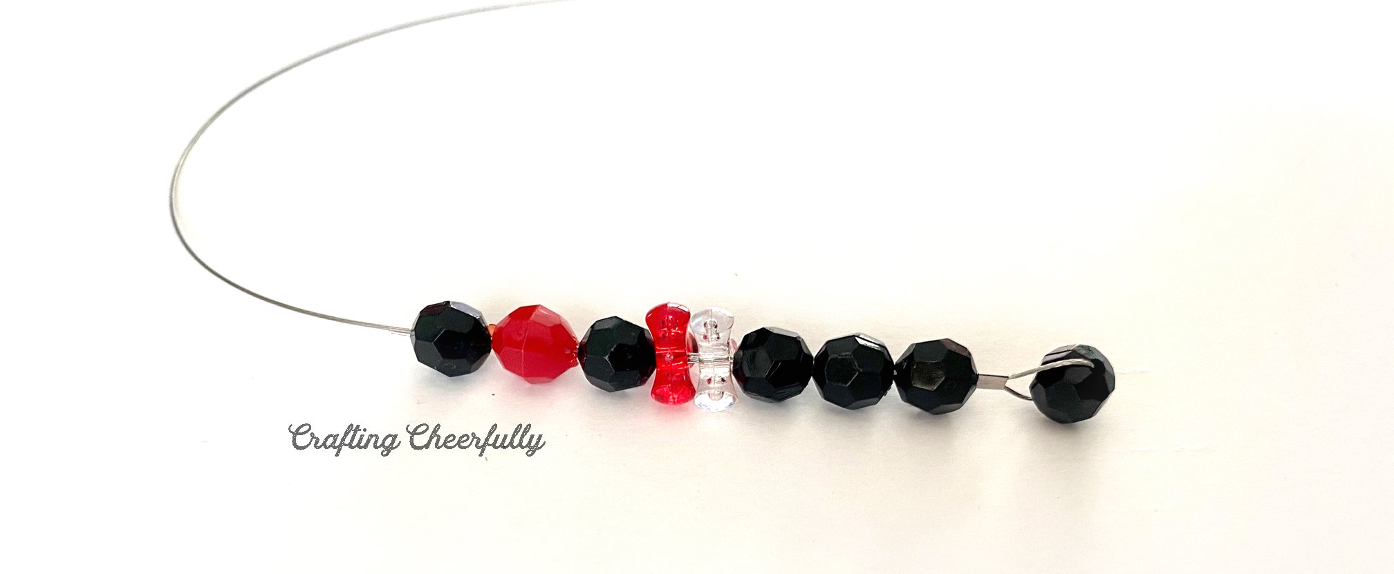 Black, red and white beads make a pattern.