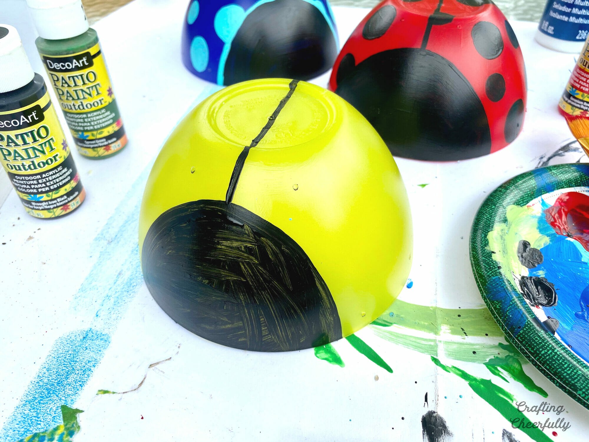 A black face and center line is painted on the bowl.
