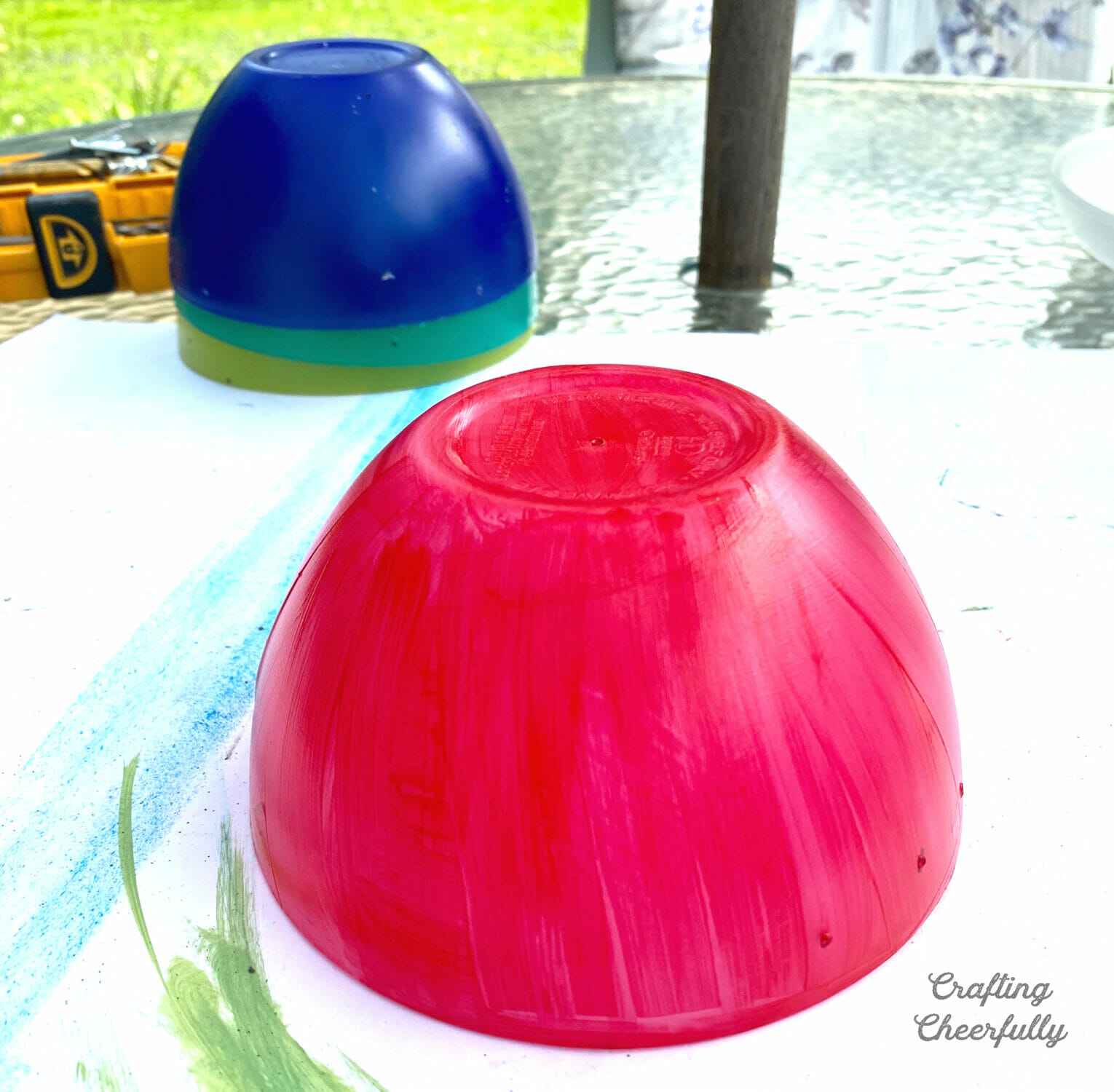Plastic bowls, one is painted red.