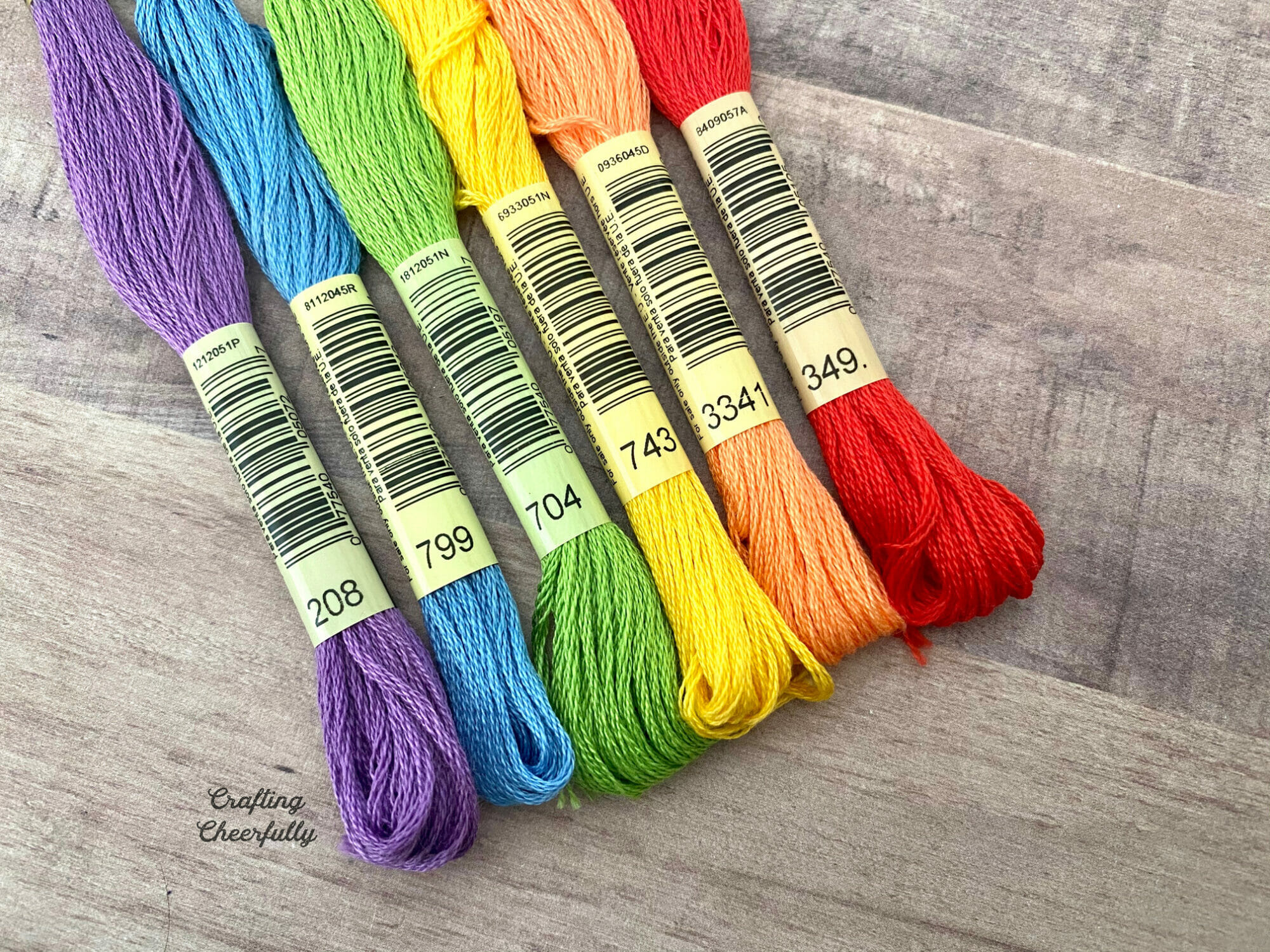 DMC Embroidery floss lined up on a table.