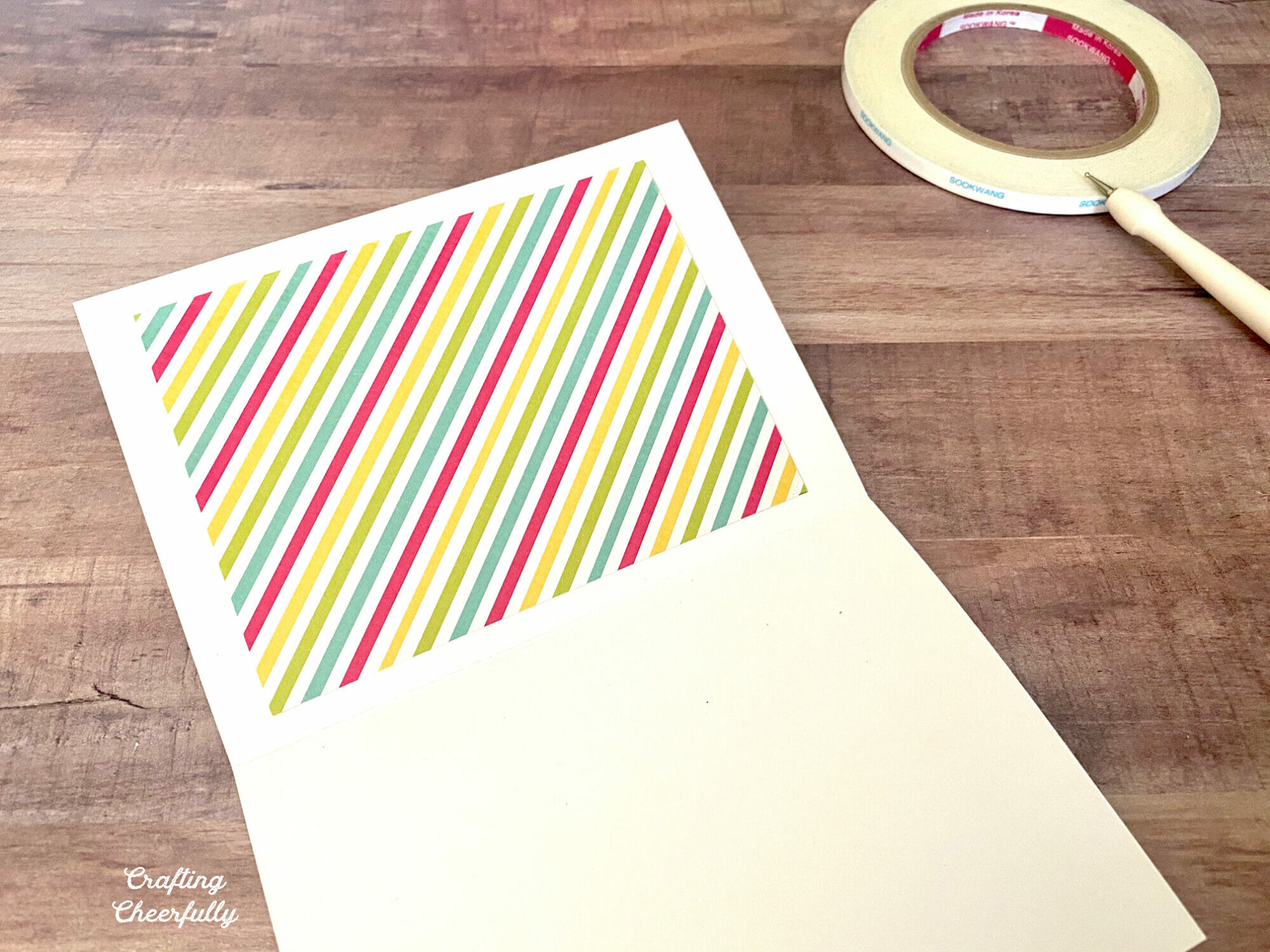 Rainbow paper is used to cover the back side of the stitched card.