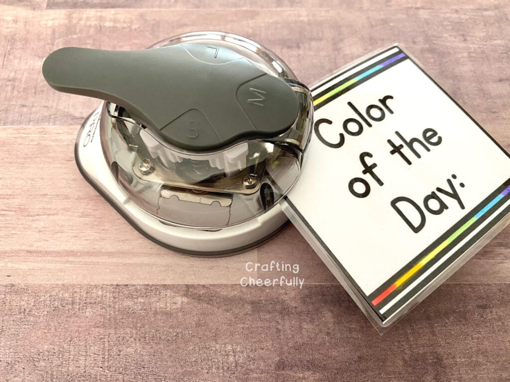 A corner punch curves the edges of a laminated calendar card.