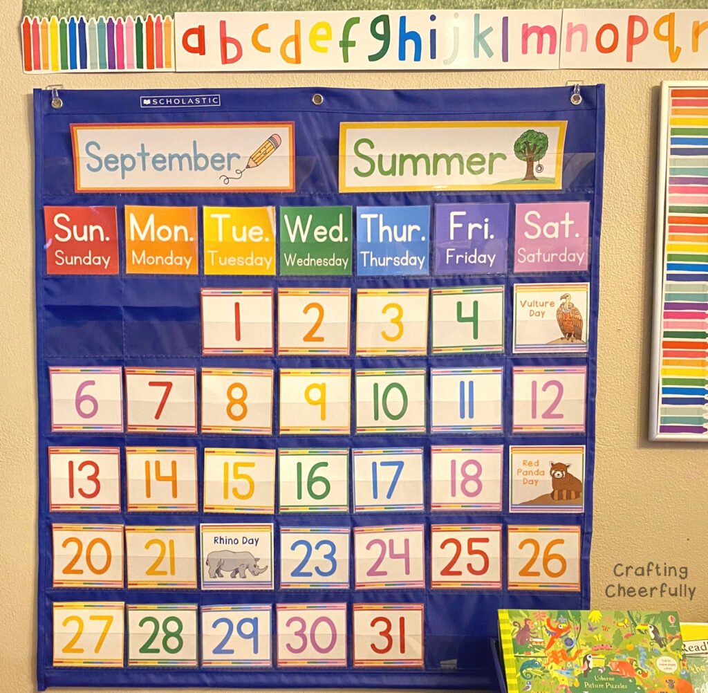 A colorful pocket chart calendar hangs in an at-home learning space.
