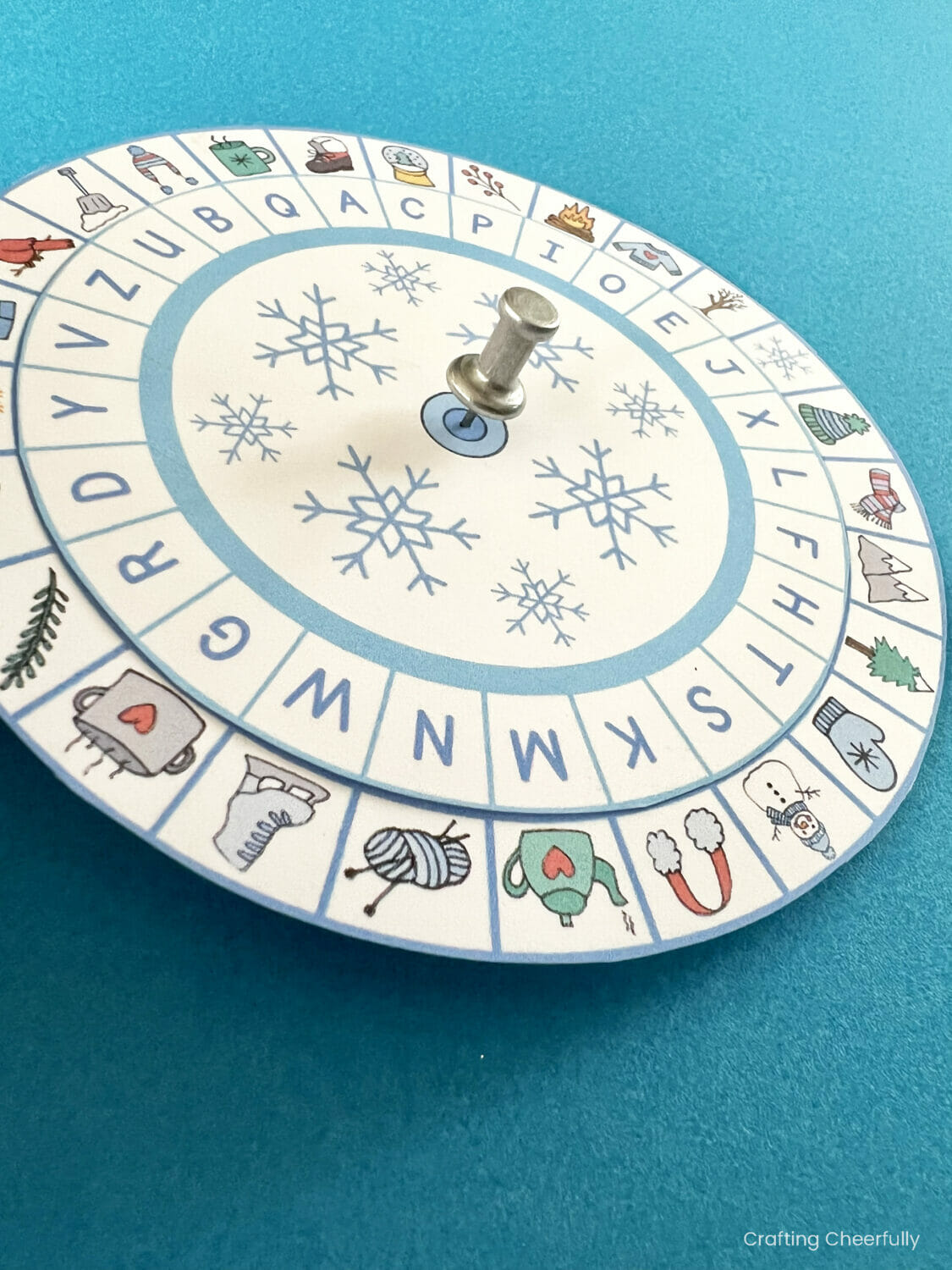 A pushpin is pushed through the center of the decoder wheels.