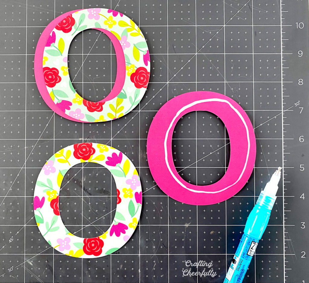 Glue is applied to O letters so they can be layered.