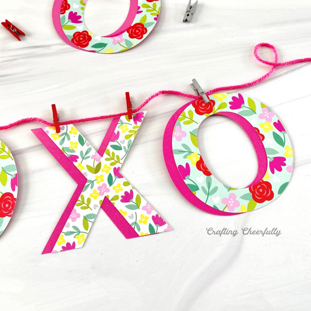 Valentine's Day banner with XO letters clipped to a pink string with mini clothespins.