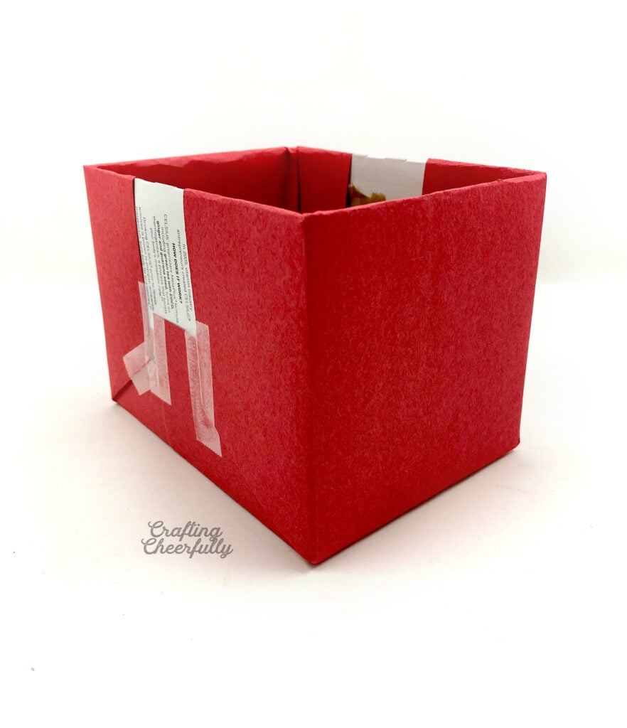 Red paper covers both ends of the cardboard box.