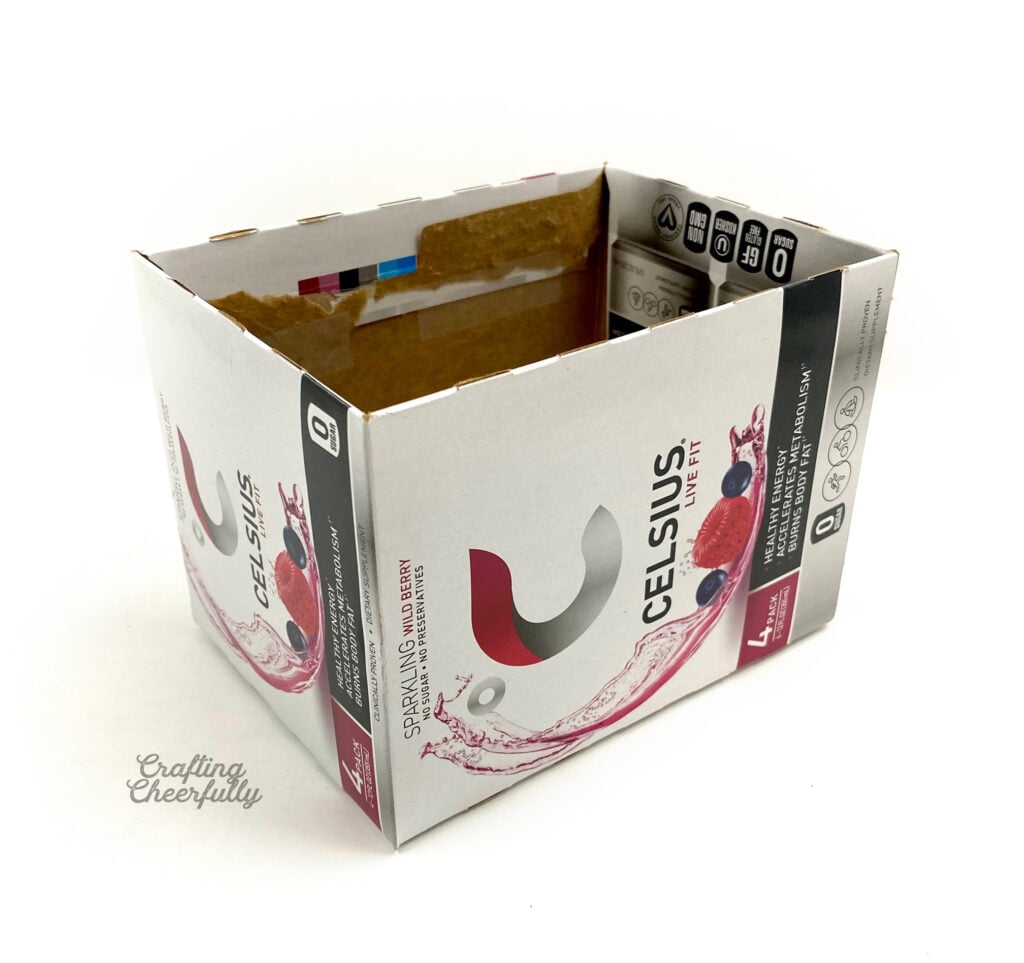 An empty cardboard box sits on a white table.