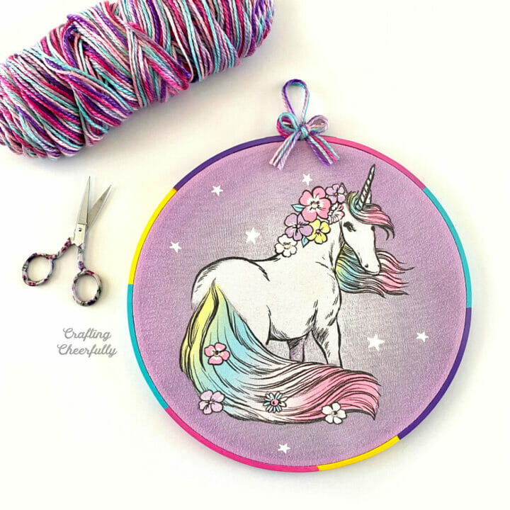 Embroidery hoop decor made with a children's t-shirt with a unicorn on it.