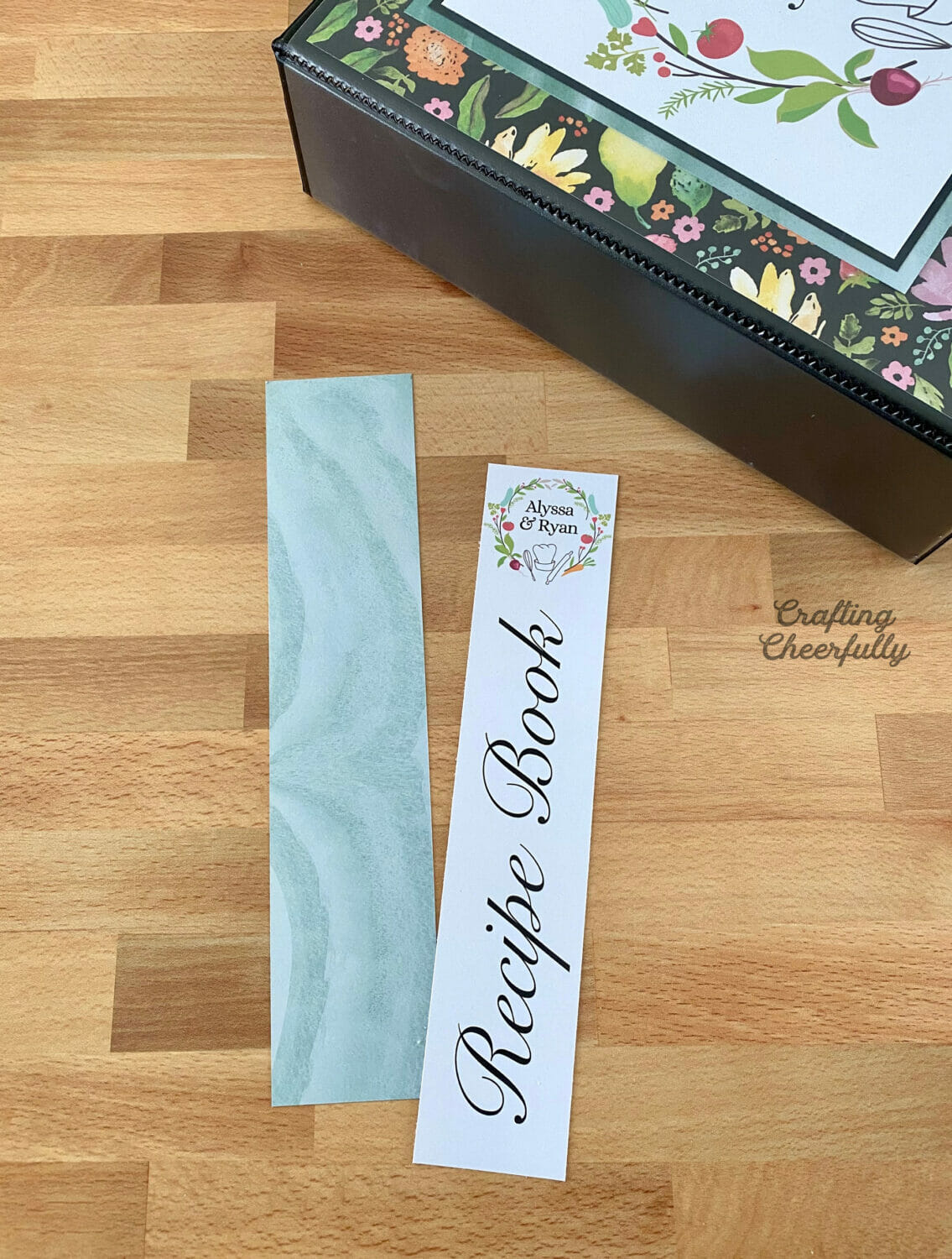 Paper labels cut for the side of the binder laying next to the black binder.
