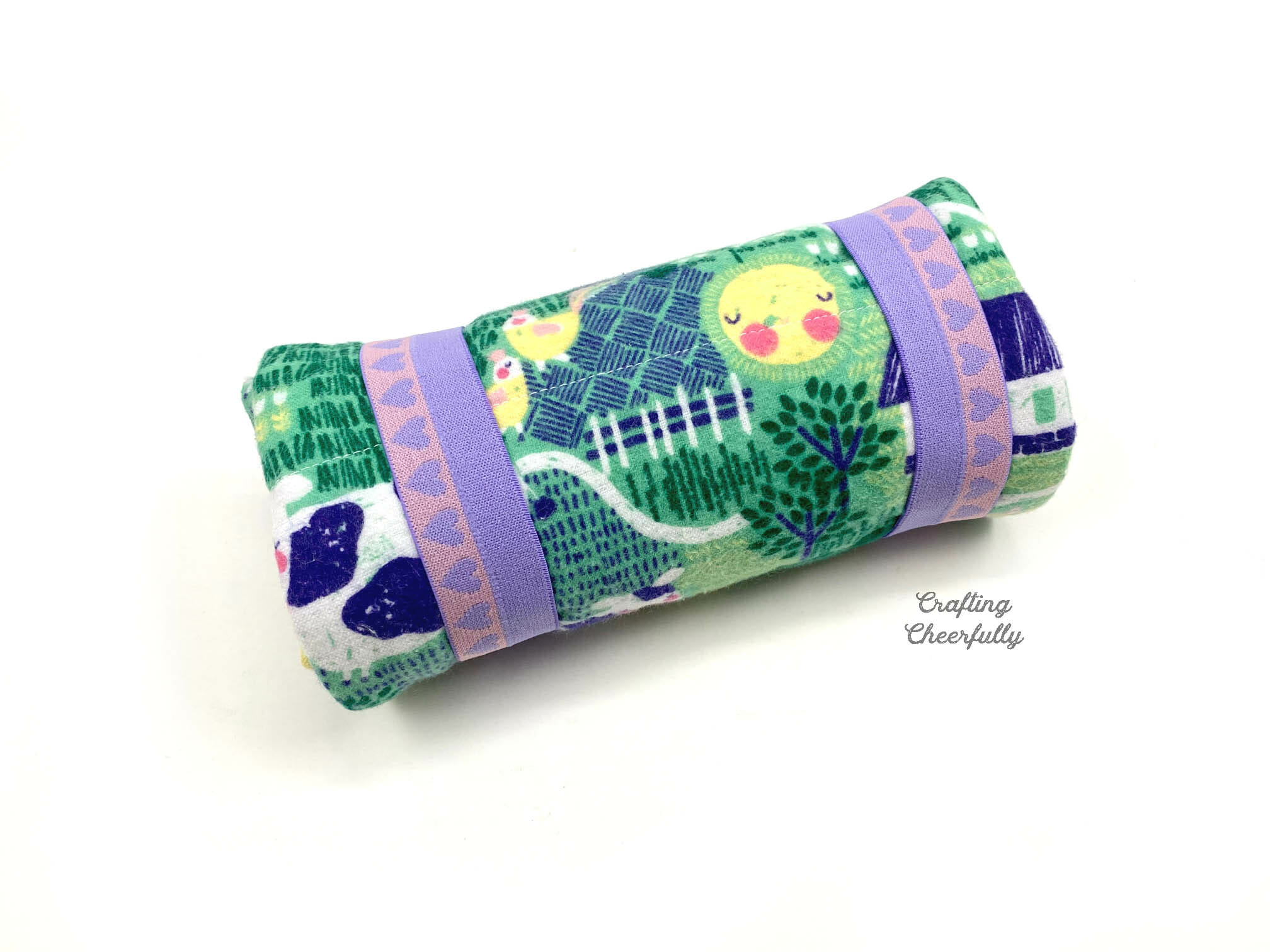Flannel sleeping bag is rolled up and held together with elsastic.